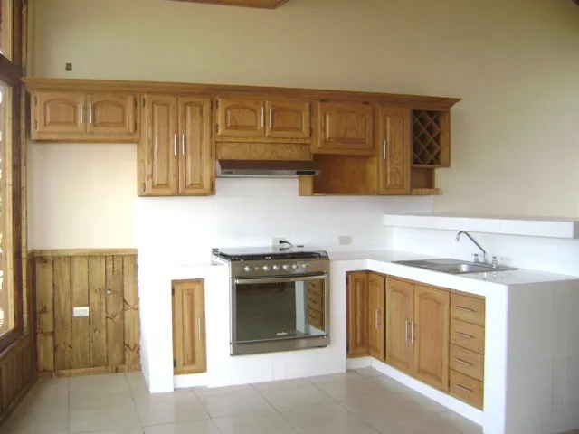 Cocina barra de concreto con azulejo y puertas y gabinetes de encino